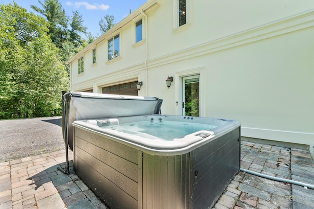 274 Sharon Tpke, Goshen, CT 06756 - view of patio / terrace featuring a hot tub and an attached garage