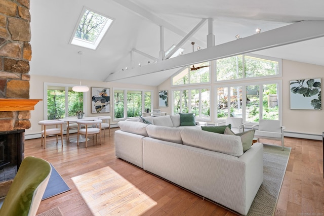 28 Codfish Ln, Weston, CT 06883 - living room with baseboard heating, a skylight, high vaulted ceiling, a stone fireplace, and beam ceiling