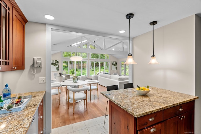 28 Codfish Ln, Weston, CT 06883 - kitchen with lofted ceiling, light stone counters, decorative light fixtures, open floor plan, and light tile patterned floors