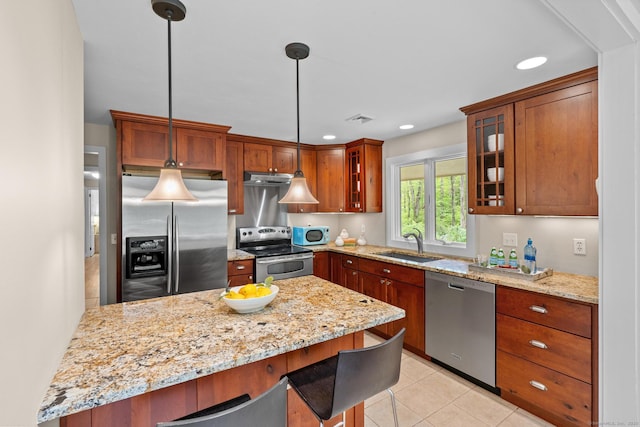 28 Codfish Ln, Weston, CT 06883 - kitchen featuring appliances with stainless steel finishes, a kitchen breakfast bar, glass insert cabinets, light stone countertops, and recessed lighting