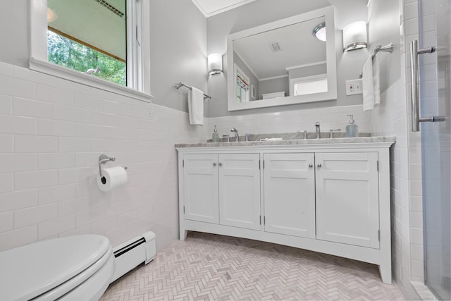28 Codfish Ln, Weston, CT 06883 - bathroom with tile walls, a baseboard heating unit, double vanity, a shower with door, and a wainscoted wall