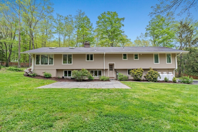 28 Codfish Ln, Weston, CT 06883 - back of house with a chimney, a patio, and a lawn