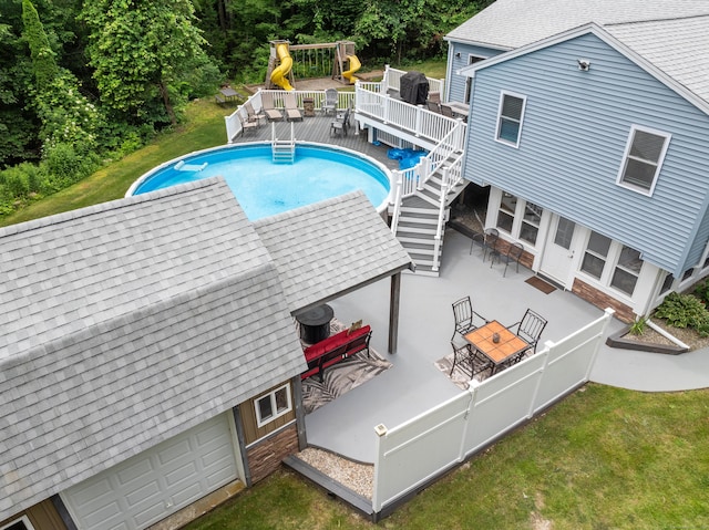 845 Five Mile River Rd, Putnam, CT 06260 - outdoor pool with a wooden deck, a lawn, stairs, a playground, and outdoor dining area
