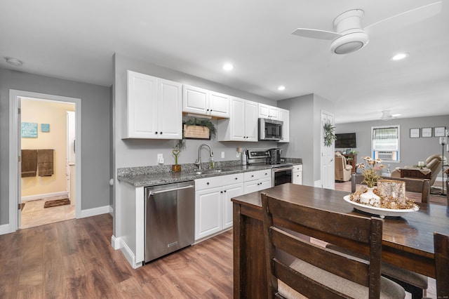 845 Five Mile River Rd, Putnam, CT 06260 - kitchen with appliances with stainless steel finishes, wood finished floors, recessed lighting, white cabinets, and ceiling fan