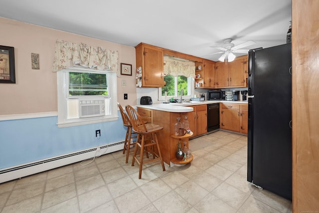 97 Edgewood Ave, Thomaston, CT 06787 - kitchen with black appliances, light countertops, a baseboard radiator, open shelves, and brown cabinets