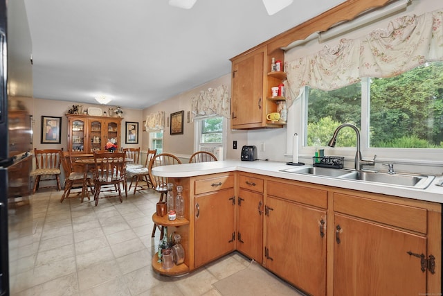 97 Edgewood Ave, Thomaston, CT 06787 - kitchen featuring open shelves, a peninsula, light countertops, and brown cabinetry