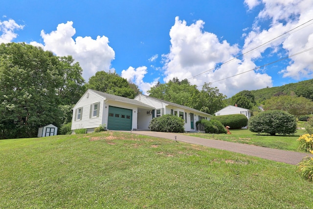 97 Edgewood Ave, Thomaston, CT 06787 - single story home featuring a garage, concrete driveway, a front lawn, and a storage unit