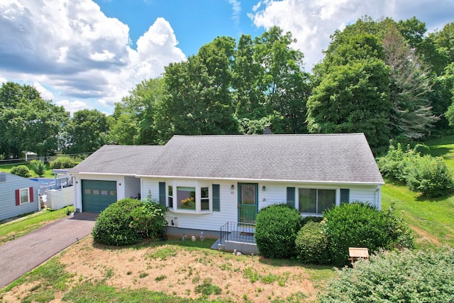 97 Edgewood Ave, Thomaston, CT 06787 - ranch-style house with an attached garage, asphalt driveway, roof with shingles, and view of scattered trees