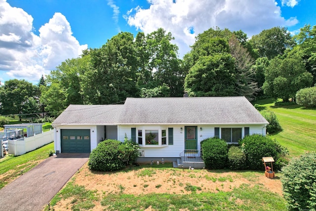 97 Edgewood Ave, Thomaston, CT 06787 - single story home featuring a garage, asphalt driveway, a front yard, a shingled roof, and view of scattered trees