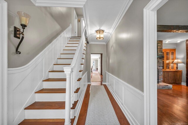 122 Nooks Hill Rd, Cromwell, CT 06416 - stairs with wood finished floors, wainscoting, ornamental molding, and a decorative wall