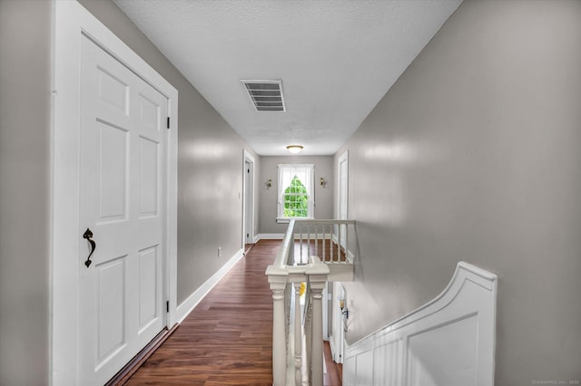 122 Nooks Hill Rd, Cromwell, CT 06416 - hallway featuring an upstairs landing, dark wood-style floors, and a textured ceiling