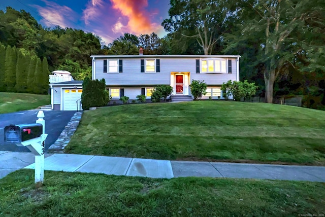 43 Berner Ter, Milford, CT 06460 - raised ranch featuring entry steps, a yard, a chimney, an attached garage, and asphalt driveway