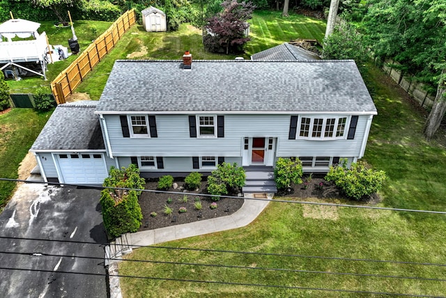 43 Berner Ter, Milford, CT 06460 - bi-level home featuring roof with shingles, a garage, asphalt driveway, and a chimney