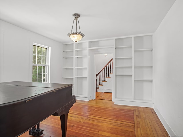 161 White St, Stratford, CT 06615 - rec room with wood-type flooring, a baseboard heating unit, and built in features