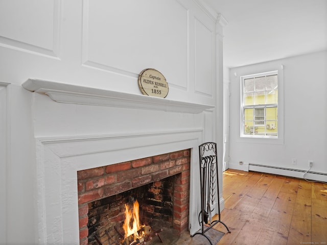 161 White St, Stratford, CT 06615 - detailed view of a brick fireplace, a baseboard heating unit, and wood finished floors
