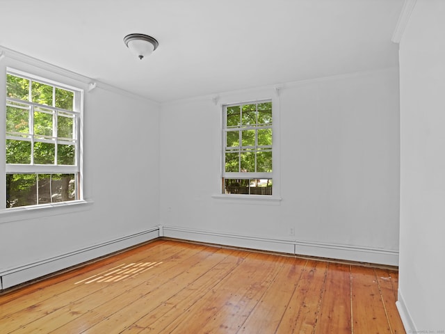 161 White St, Stratford, CT 06615 - empty room featuring plenty of natural light, baseboard heating, wood-type flooring, and ornamental molding