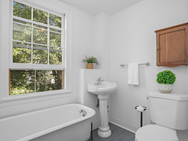 161 White St, Stratford, CT 06615 - bathroom featuring a freestanding bath and wood finished floors