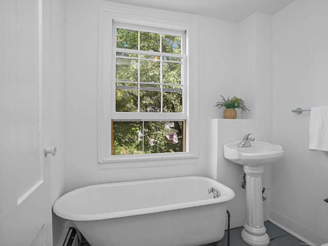 161 White St, Stratford, CT 06615 - bathroom featuring a freestanding bath, tile patterned floors, and a baseboard radiator