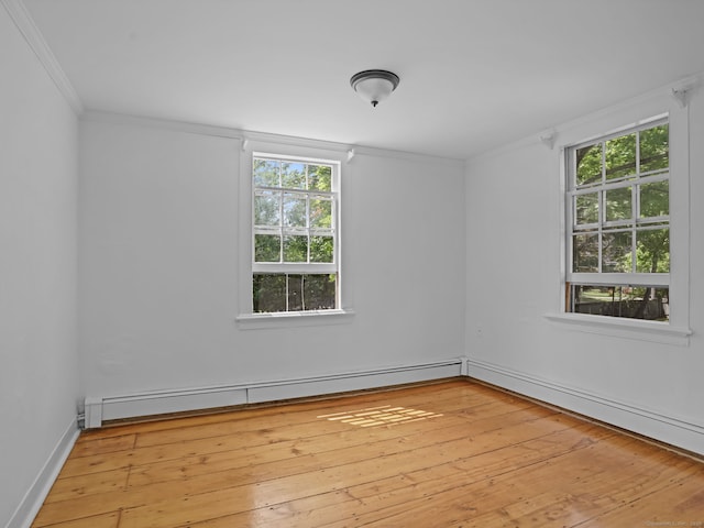 161 White St, Stratford, CT 06615 - empty room with a baseboard radiator, crown molding, and light wood-style flooring