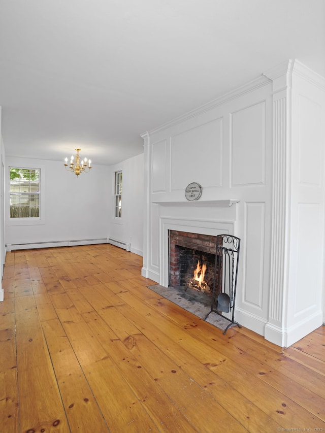 161 White St, Stratford, CT 06615 - unfurnished living room featuring a chandelier, a brick fireplace, and light wood-style flooring