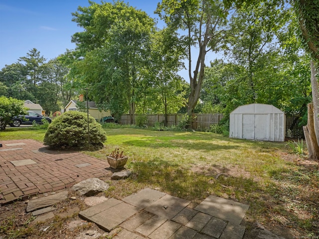 161 White St, Stratford, CT 06615 - fenced backyard featuring a storage shed, a patio area, and view of wooded area