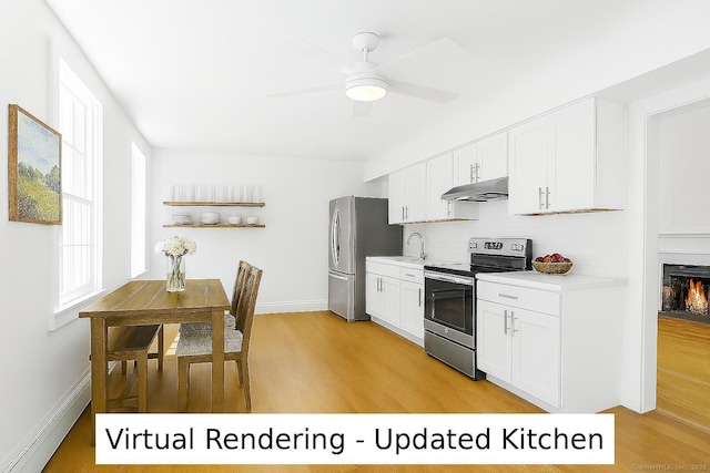 161 White St, Stratford, CT 06615 - kitchen featuring appliances with stainless steel finishes, under cabinet range hood, light countertops, and light wood-style flooring