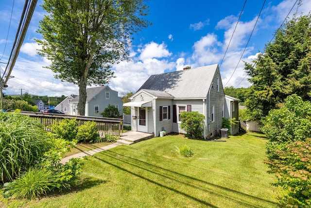 15 Boardman St, Bristol, CT 06010 - rear view of house with a yard, a chimney, a wooden deck, and roof with shingles