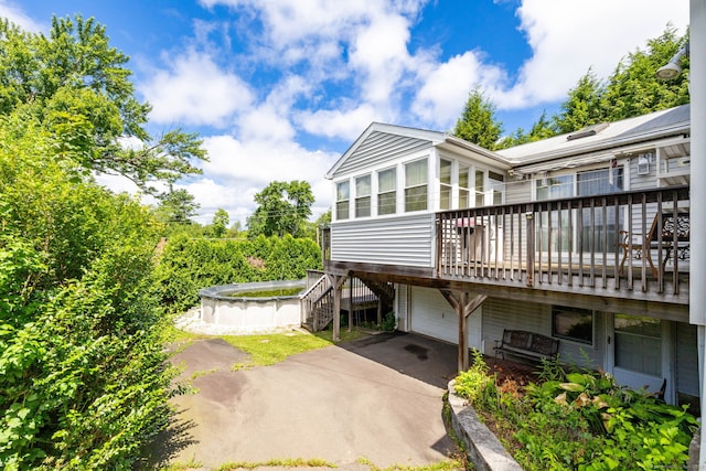 15 Boardman St, Bristol, CT 06010 - view of front of property featuring driveway, stairs, a garage, and a deck