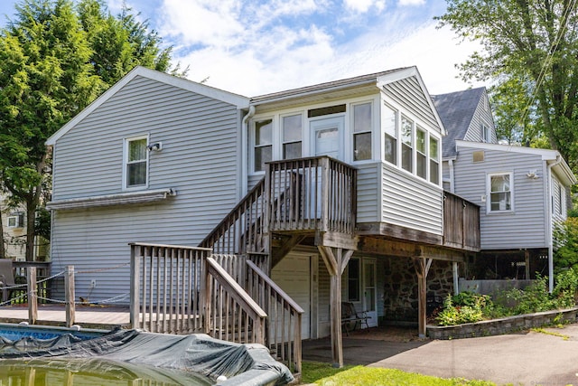 15 Boardman St, Bristol, CT 06010 - back of property with a deck, stone siding, and stairs