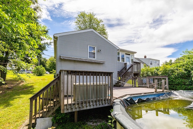 15 Boardman St, Bristol, CT 06010 - back of property with stairs, a wooden deck, an attached garage, and concrete driveway