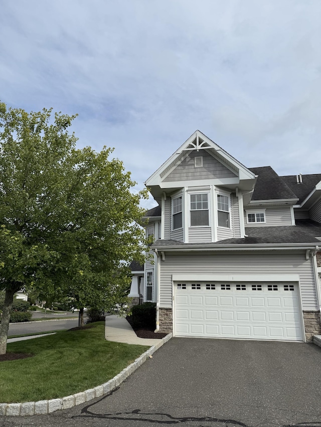 1 Sampson Ter Unit 801, Danbury, CT 06810 - view of front of home with stone siding, a garage, driveway, a front yard, and roof with shingles