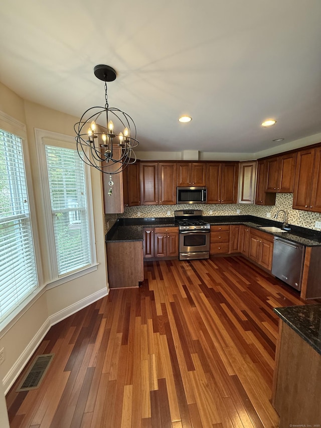 1 Sampson Ter Unit 801, Danbury, CT 06810 - kitchen with appliances with stainless steel finishes, dark wood-style flooring, a chandelier, decorative backsplash, and recessed lighting
