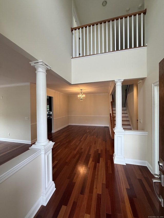 1 Sampson Ter Unit 801, Danbury, CT 06810 - unfurnished living room with a towering ceiling, wood finished floors, stairway, and ornate columns