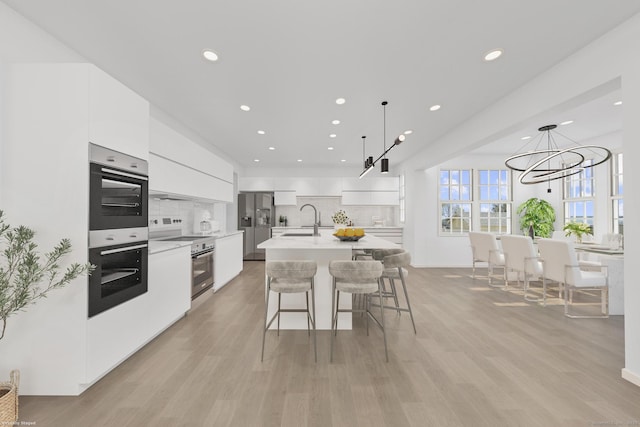 47 Lucey Ave, West Haven, CT 06516 - kitchen featuring range with electric cooktop, modern cabinets, double oven, white cabinets, and light countertops