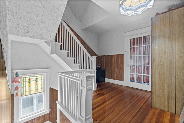 103 Eaton St, Bridgeport, CT 06604 - stairs featuring wood-type flooring, a skylight, wooden walls, and wainscoting