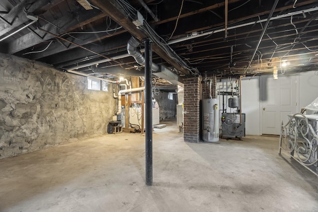 103 Eaton St, Bridgeport, CT 06604 - below grade area with gas water heater, a heating unit, and washer / dryer