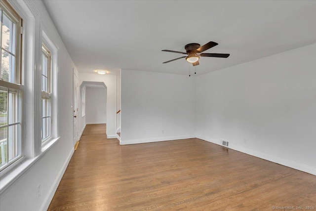 270 Hills St, East Hartford, CT 06118 - empty room featuring a ceiling fan, wood finished floors, and arched walkways