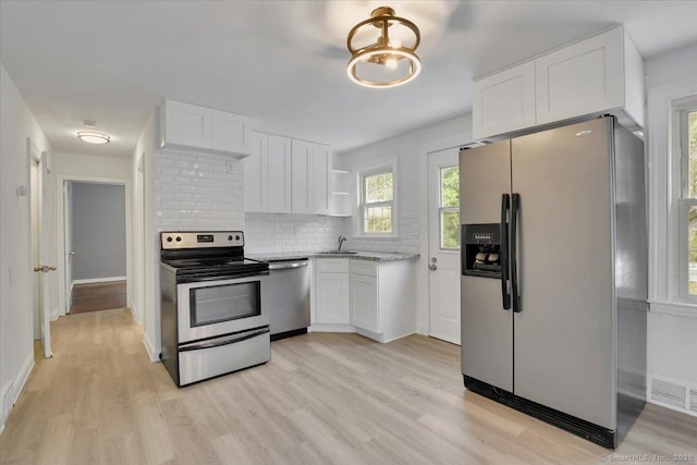 270 Hills St, East Hartford, CT 06118 - kitchen with stainless steel appliances, white cabinets, open shelves, and light wood finished floors