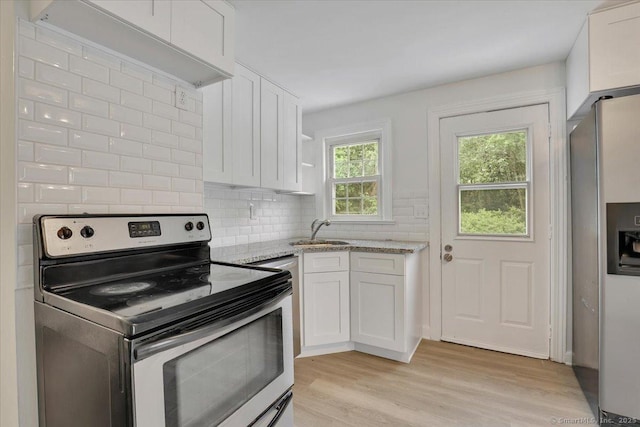 270 Hills St, East Hartford, CT 06118 - kitchen featuring stainless steel appliances, white cabinetry, light wood-type flooring, light stone counters, and backsplash
