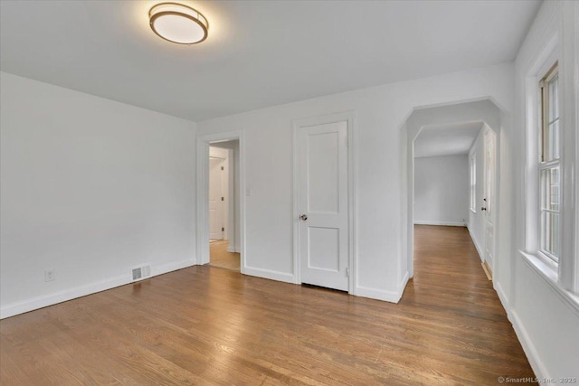 270 Hills St, East Hartford, CT 06118 - unfurnished room with arched walkways and wood finished floors