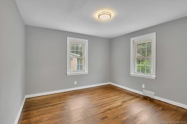 270 Hills St, East Hartford, CT 06118 - empty room with healthy amount of natural light and wood finished floors