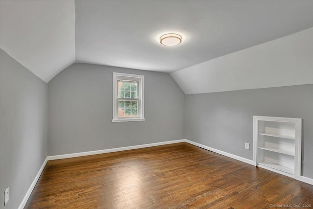 270 Hills St, East Hartford, CT 06118 - additional living space with lofted ceiling, dark wood-style floors, and built in shelves