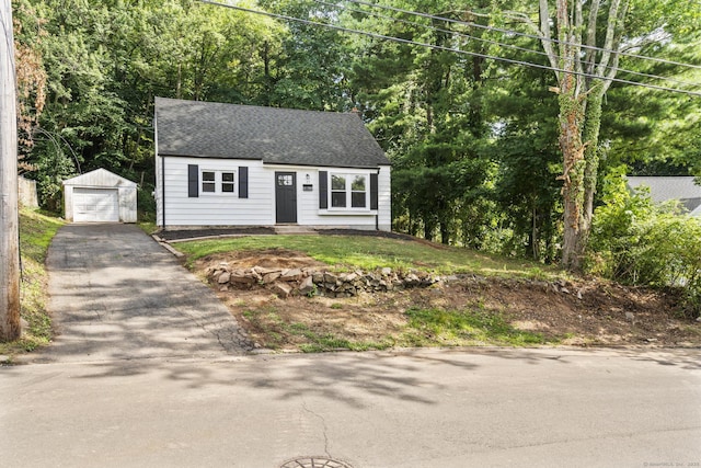 17 Norwood Rd, New Haven, CT 06513 - view of front of home featuring driveway, an outbuilding, roof with shingles, and a garage