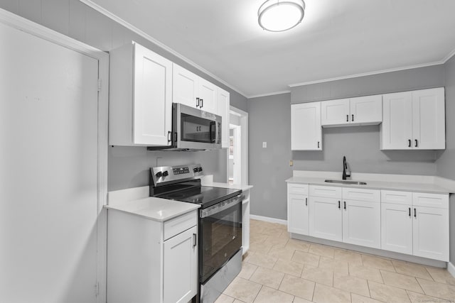 17 Norwood Rd, New Haven, CT 06513 - kitchen featuring stainless steel appliances, light countertops, crown molding, and white cabinets