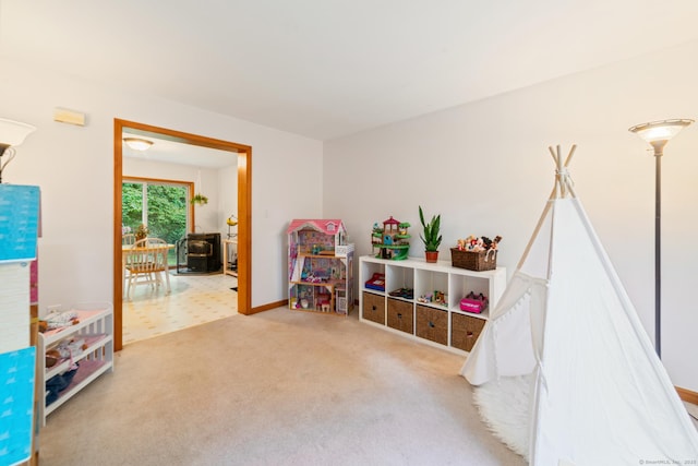 195 Crane Hollow Rd, Bethlehem, CT 06751 - playroom with a wood stove and carpet flooring