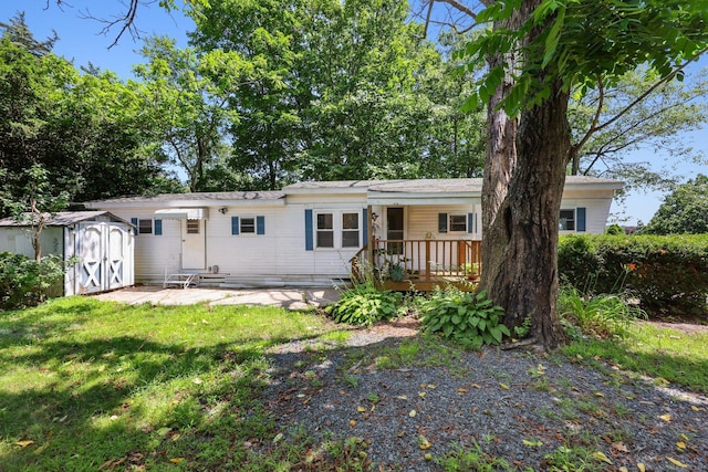 133 W Main St Trlr C6, Clinton, CT 06413 - view of front of home with a storage unit, a front yard, and a wooden deck