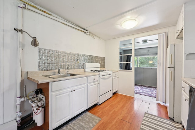 133 W Main St Trlr C6, Clinton, CT 06413 - kitchen featuring white appliances, white cabinetry, decorative backsplash, light wood-style floors, and light countertops