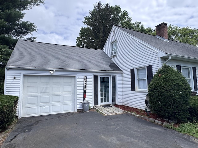 190 Elm St, Windsor Locks, CT 06096 - view of front of house with a chimney, driveway, and a shingled roof