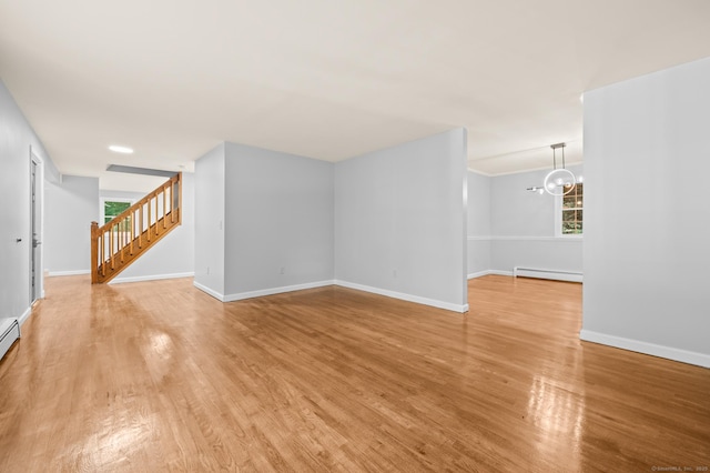 7 Woodmont Rd, Avon, CT 06001 - unfurnished living room with light wood-type flooring, a baseboard heating unit, stairway, a chandelier, and plenty of natural light