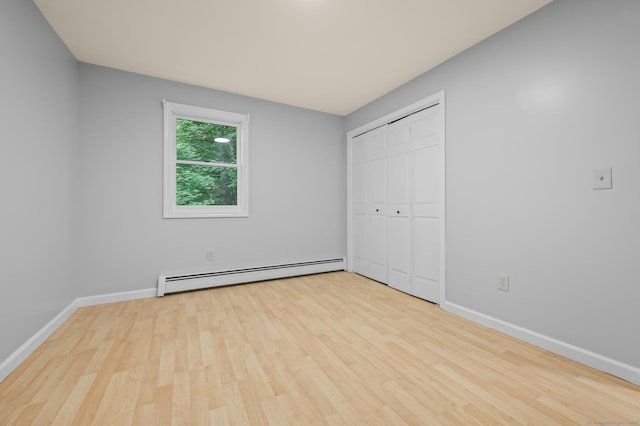 7 Woodmont Rd, Avon, CT 06001 - unfurnished bedroom with a baseboard heating unit, wood finished floors, and a closet